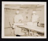 Shipboard Life. Doctors preparing operating table